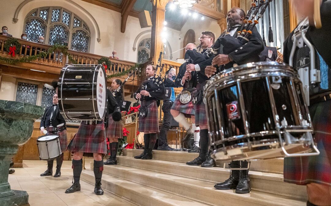 Scottish musicians in kilts performing on a church stage